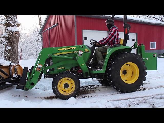 John Deere 3038E with attachments